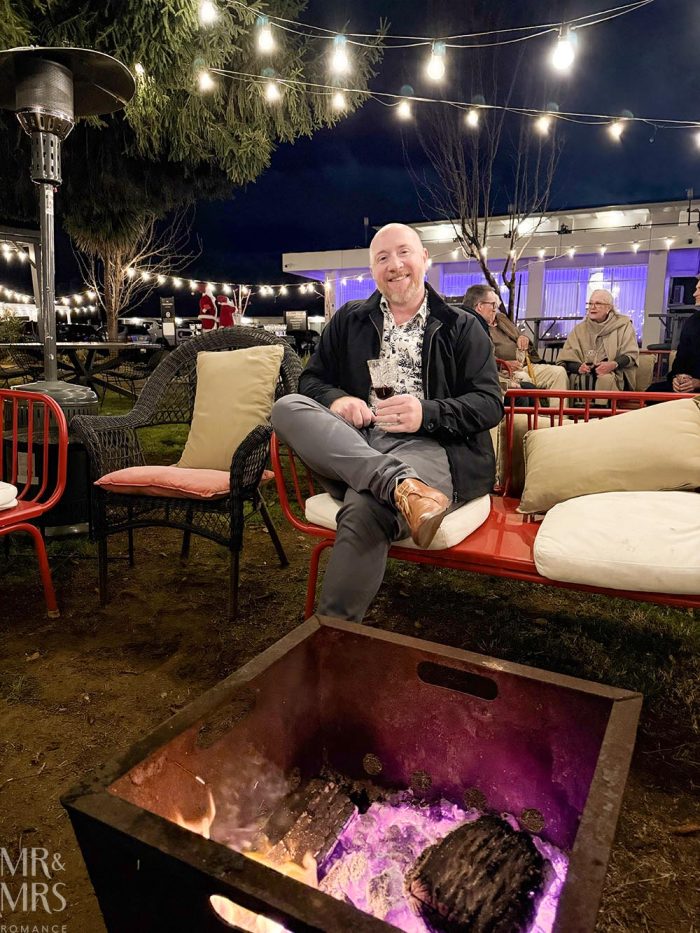 Christmas in July, Oriana Motel, Orange, NSW - Jim sitting by the fire pit with a glass of Norwegian wine