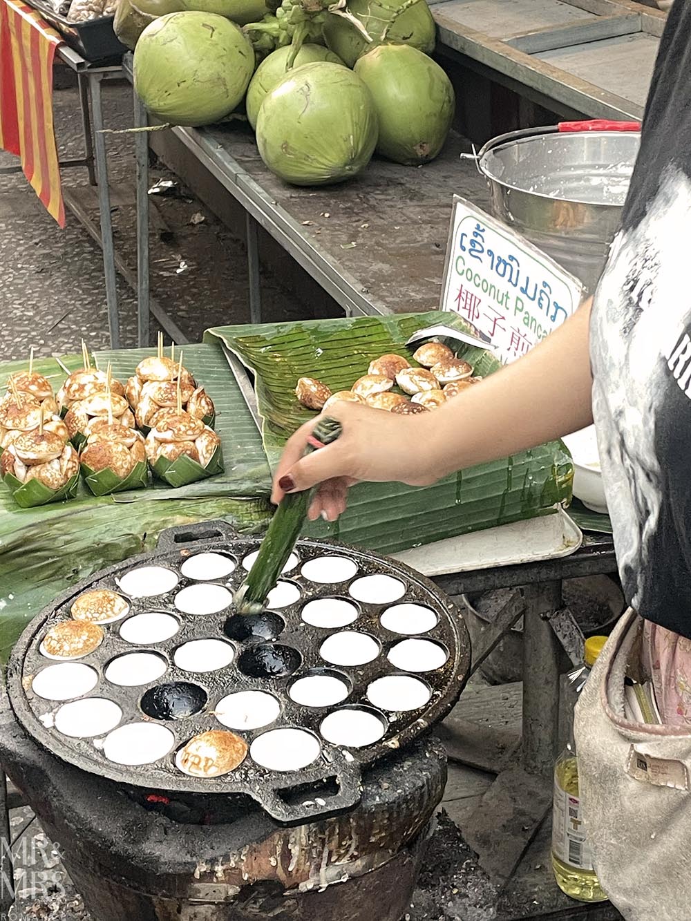 Things to eat in Laos - kanom krok being made in a special pan