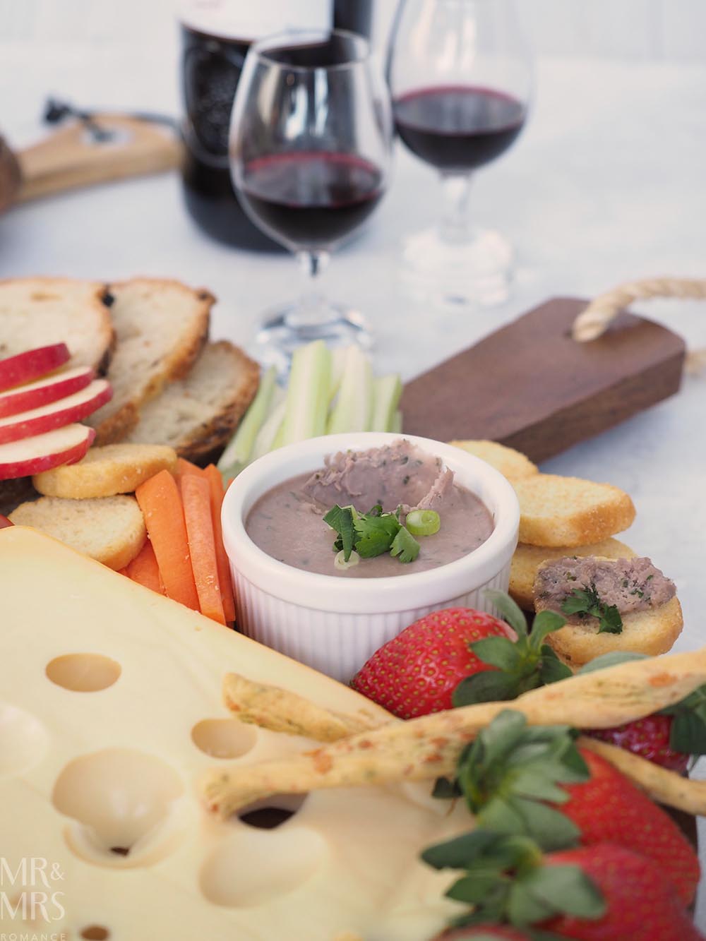 Port and Gorgonzola pate recipe - pate is nestled amongst a variety of cheeses, fruit and crackers, and there are two glasses of port at the top of the shot