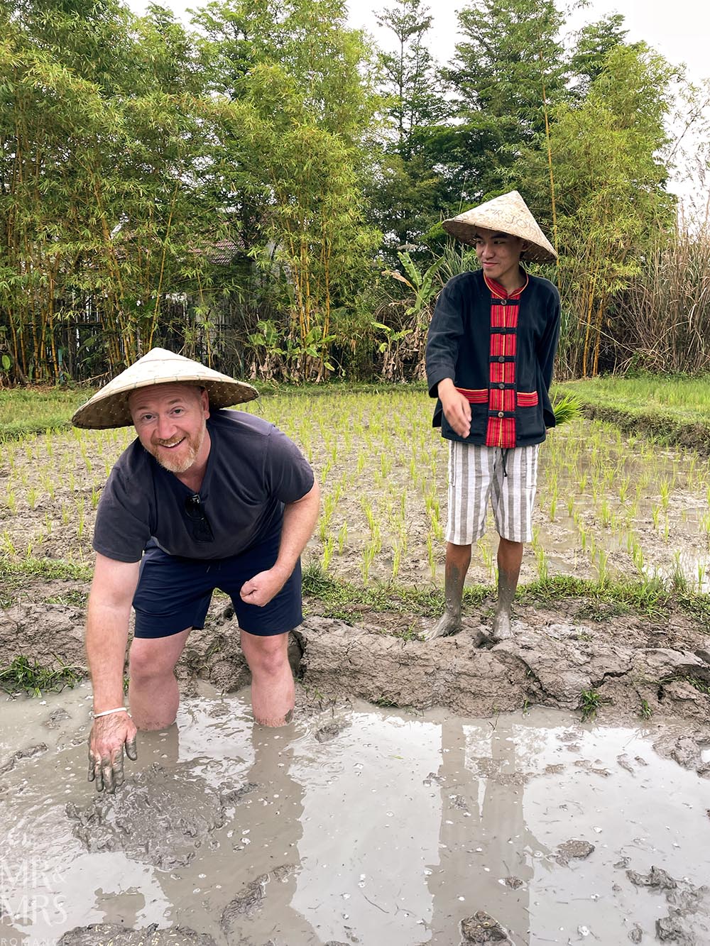 Living Land Farm Company, Luang Prabang, Laos - Jim in a rice paddy planting rice seeds