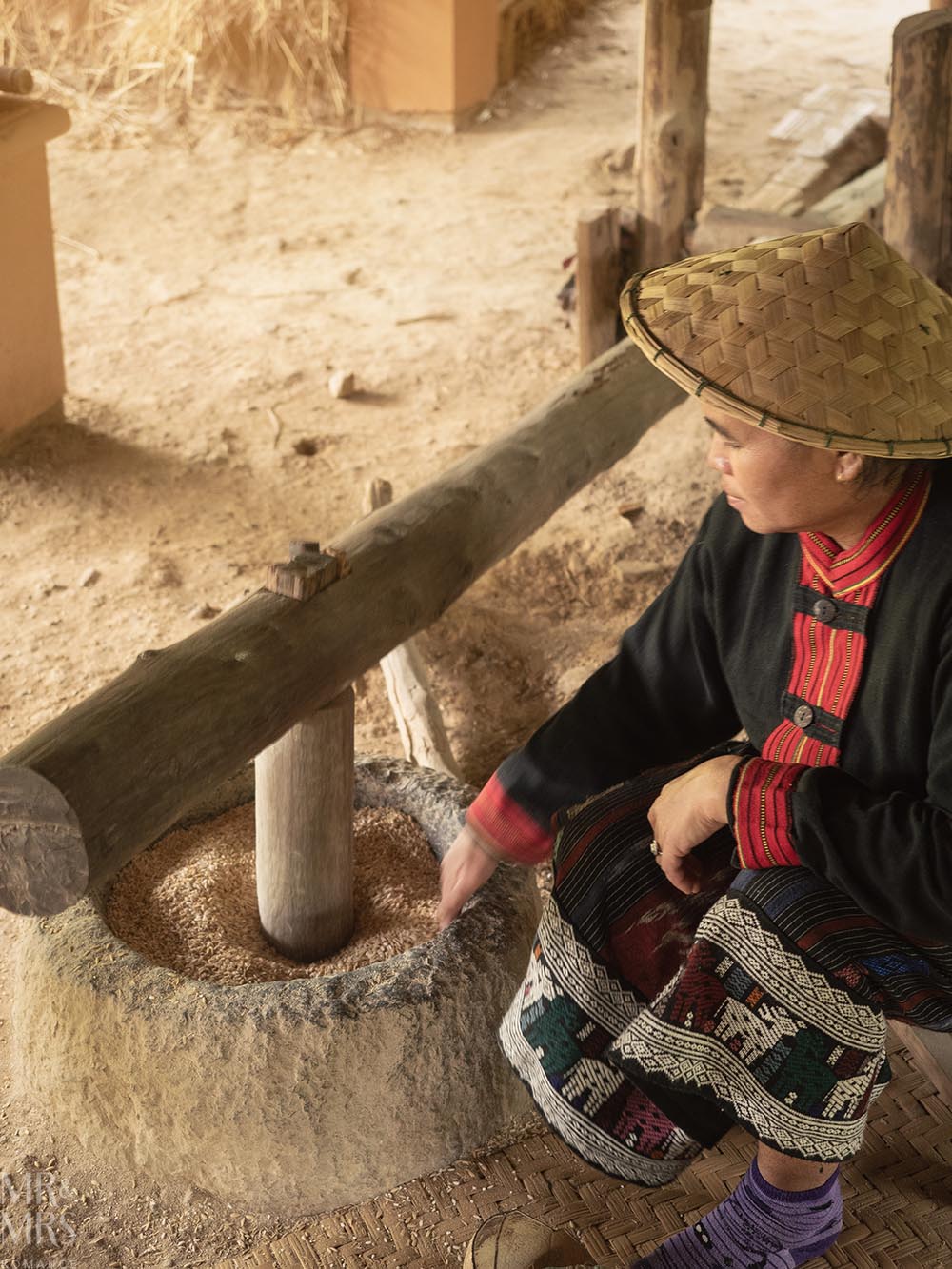 Living Land Farm Company, Luang Prabang, Laos - pounding rice grains to remove shell
