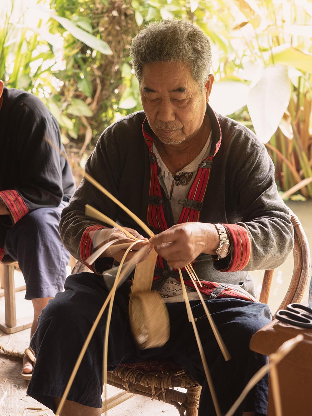 Living Land Farm Company, Luang Prabang, Laos - farmer weaving bamboo and rice stalks to create art and tools
