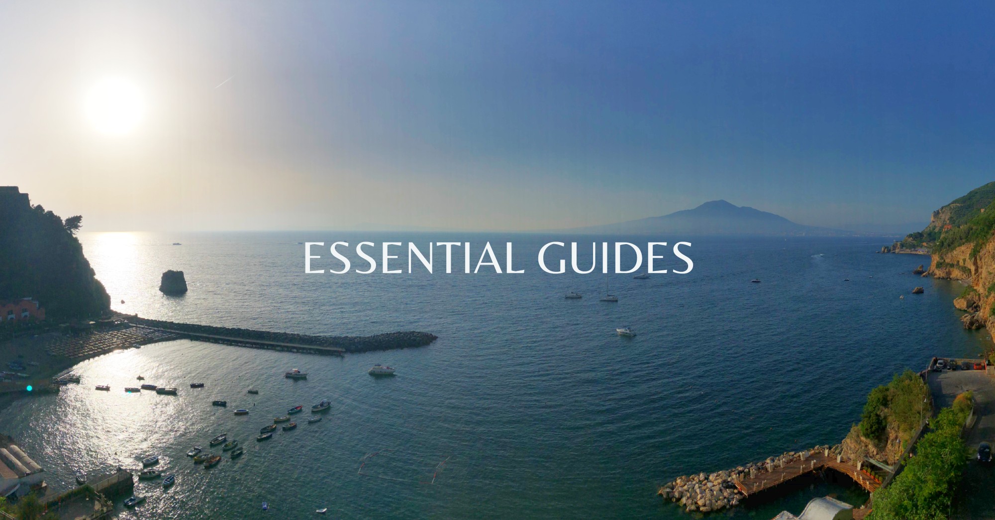 Christina and Jim - Mr and Mrs Romance and view out over Amalfi Coast - hero image for Essential Guides hub page